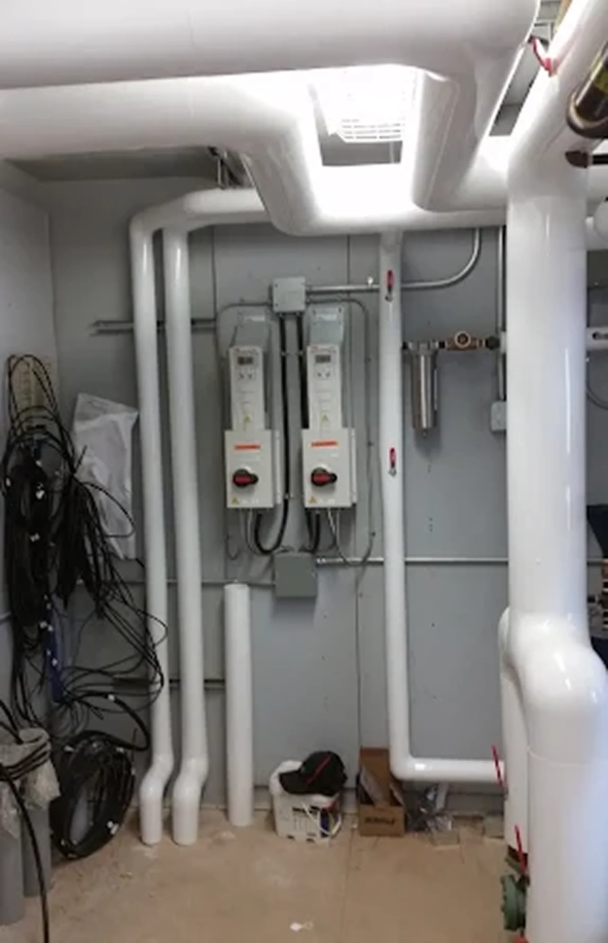 Pipes and electrical equipment in utility room.