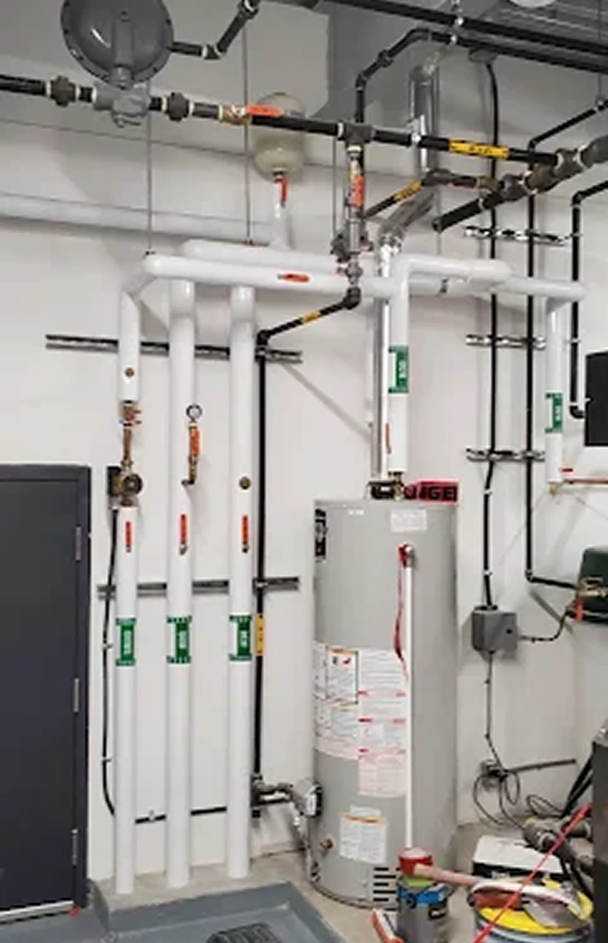 Boiler room with pipes and water heater.