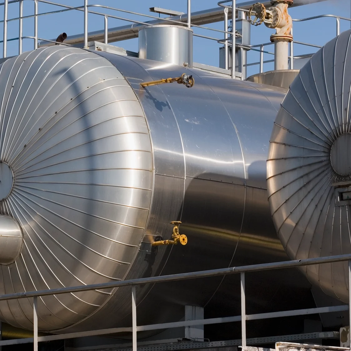 Large industrial metal storage tanks outdoors.